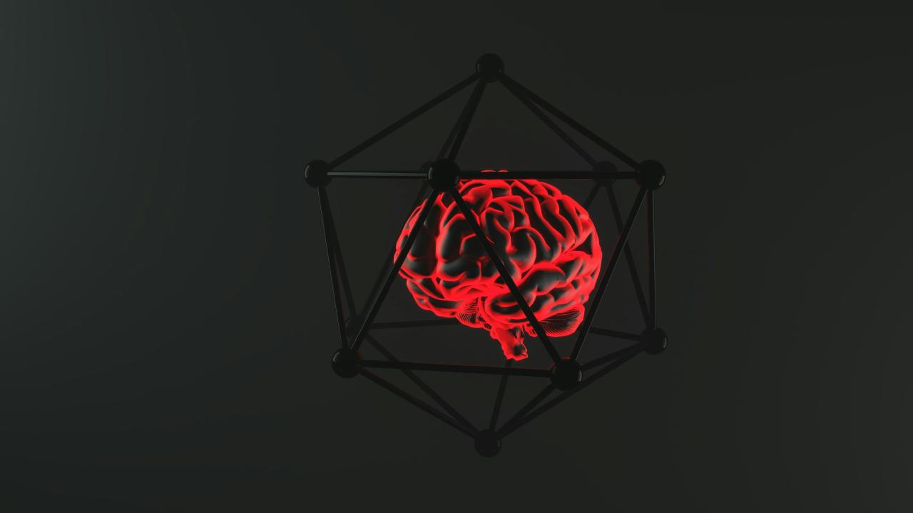 Glowing brain encased in a geometric structure.